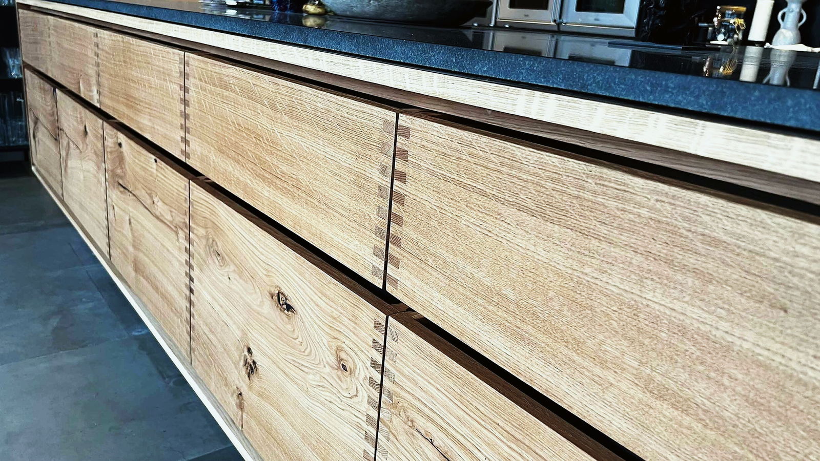 The dovetailed oak drawer fronts running the length of the island