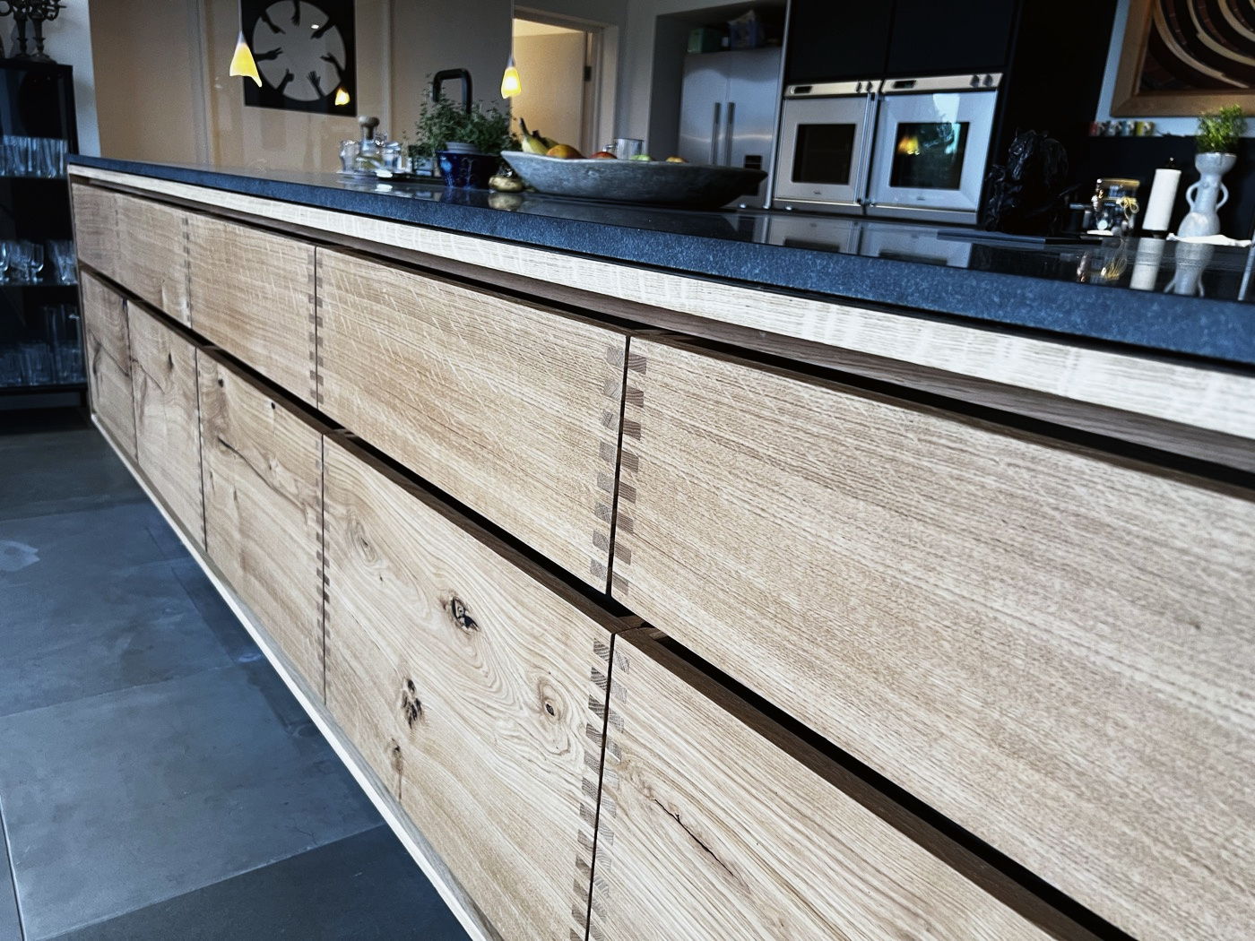 A bespoke kitchen island with solid oak and black cabinetry