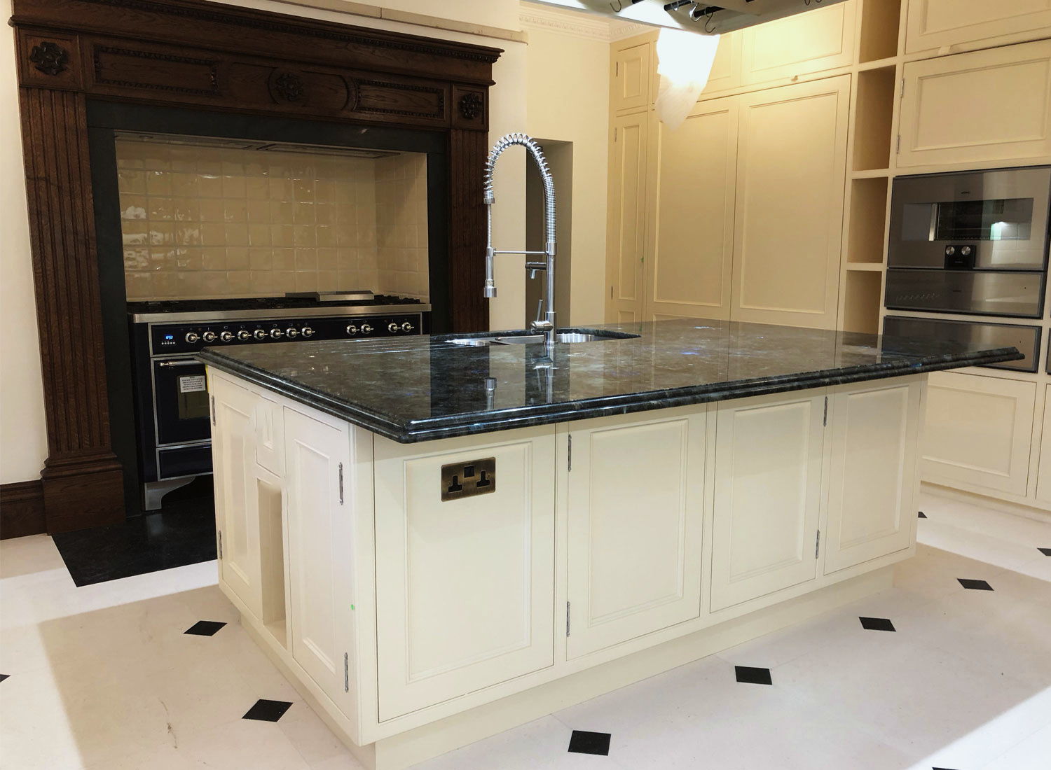 A moulded kitchen island near a fireplace
