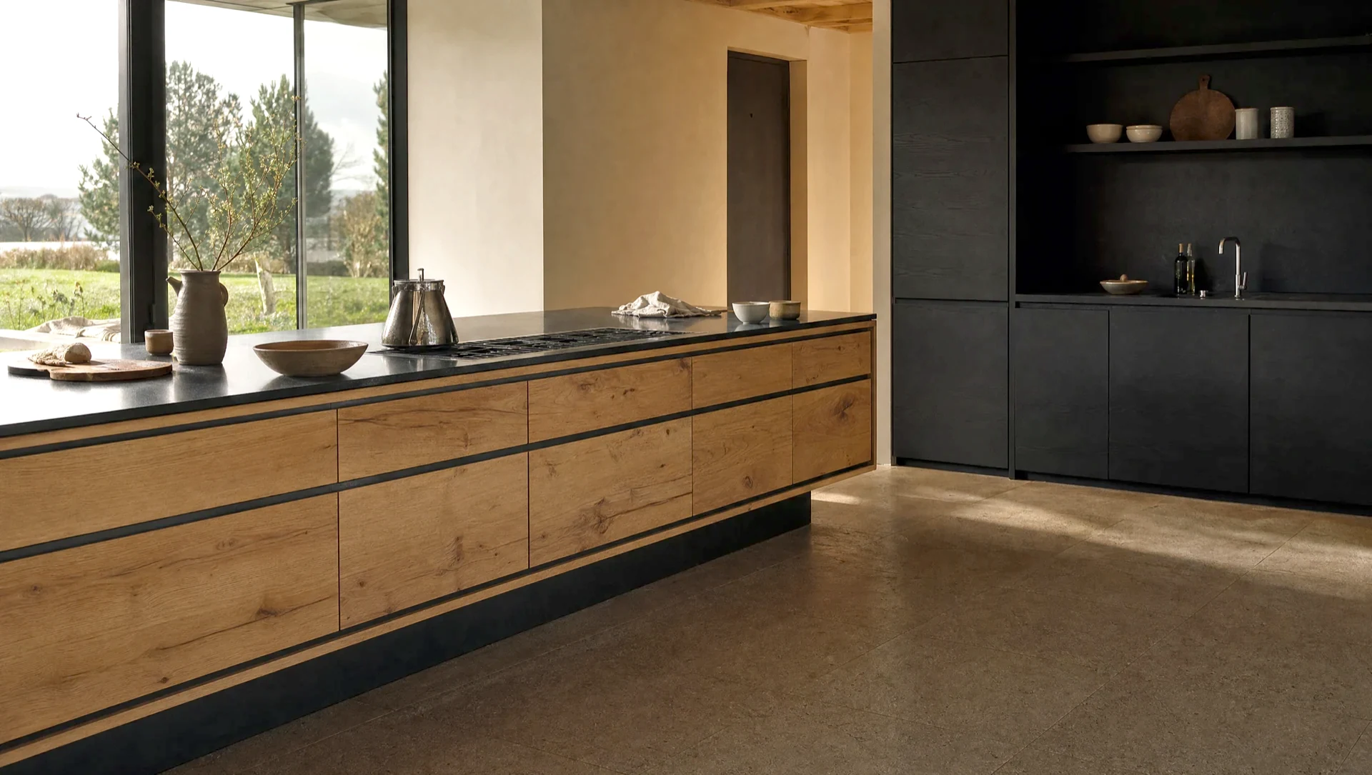 A matt black run with a stone worktop alongside character oak, The Scandi range by Square & True