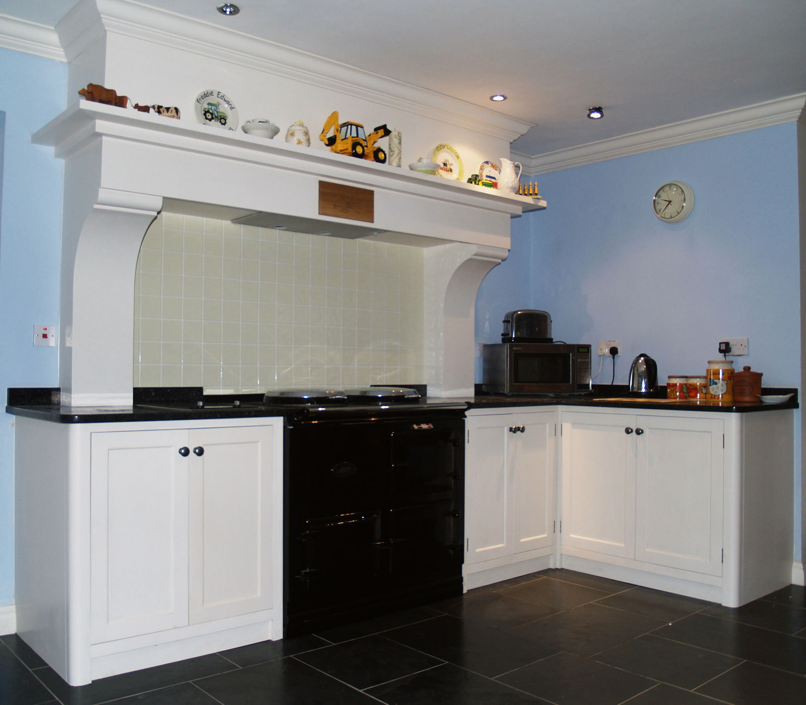The painted chimneypiece over the range, with a shelf above