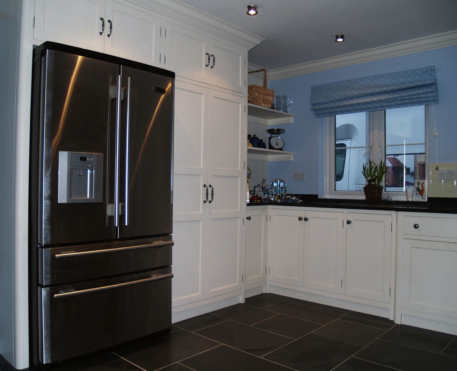 A tall painted housing built around the fridge