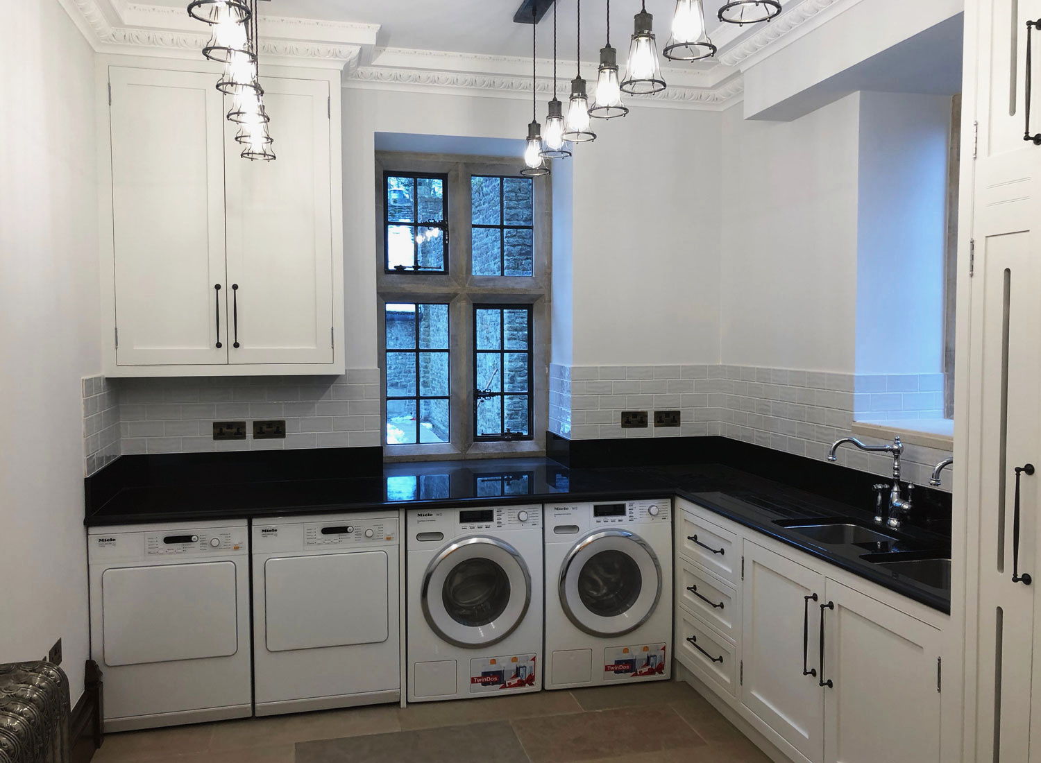 Painted slatted-door cupboards over a laundry run