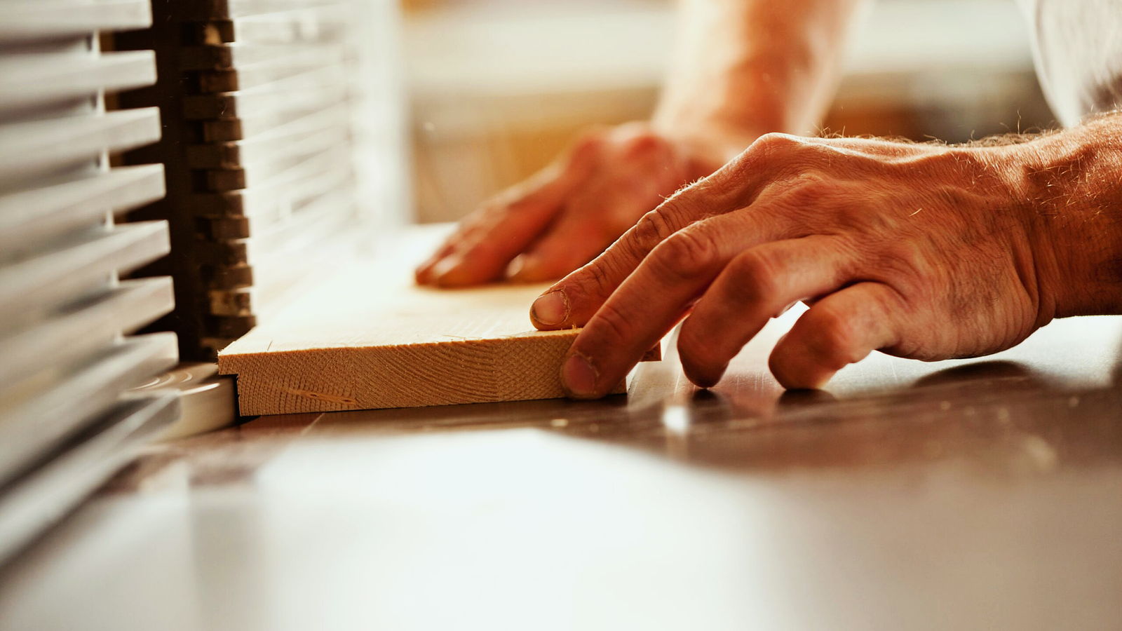 A cabinetmaker’s hands at work on the bench in the Suffolk workshop
