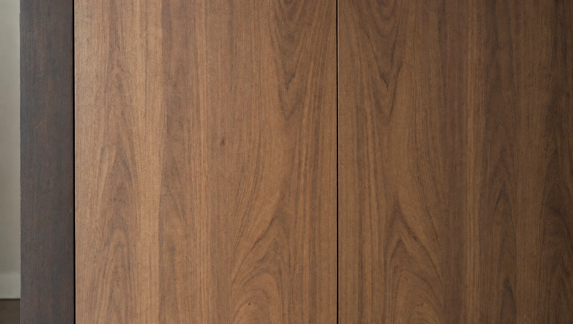 Detail of a sprayed handleless front in book-matched veneer, The Kensington range by Square & True