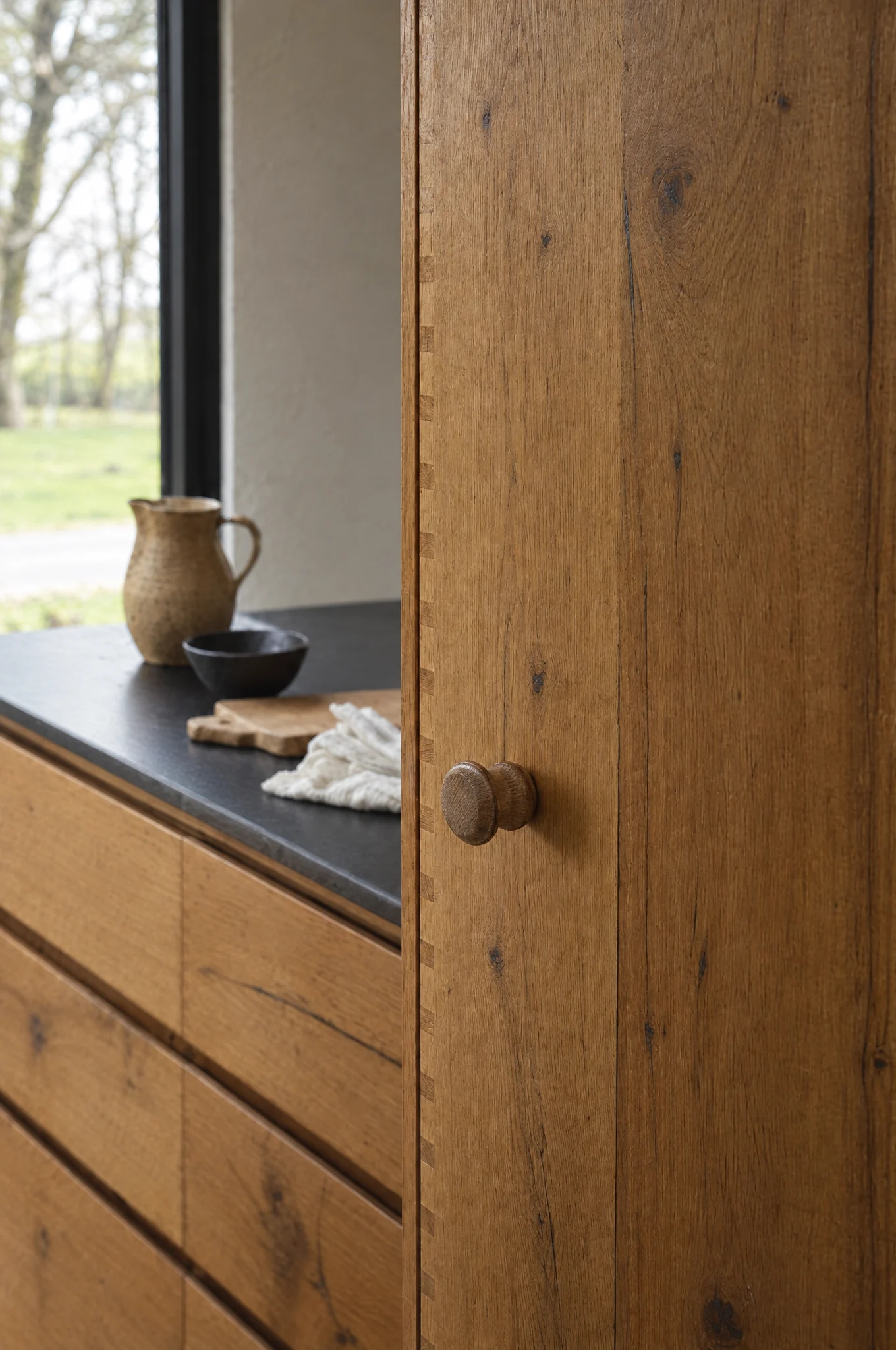 A turned oak knob on a character oak larder door, The Scandi range by Square & True